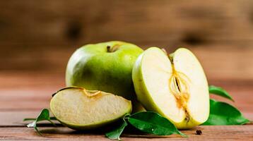 Juicy apples with leaves on the table. photo