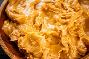 Peanut butter on a plate. Macro background. photo