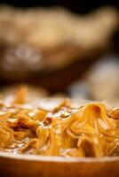 Peanut butter on a plate. Macro background. photo