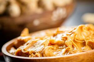 Peanut butter on a plate. Macro background. photo