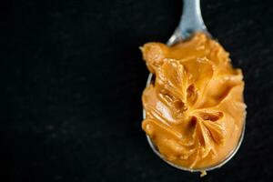 A spoonful full of peanut butter. photo