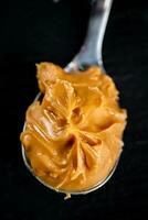 A spoonful full of peanut butter. photo