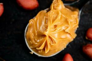 A spoonful full of peanut butter. photo