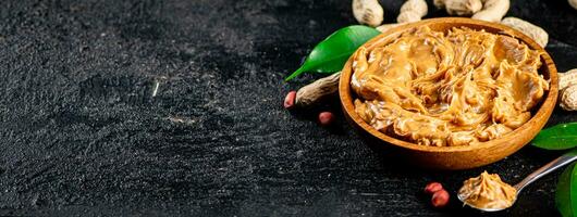 Peanut butter in a plate and spoon. photo