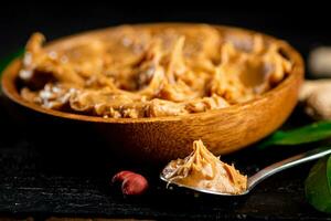 Peanut butter in a plate and spoon. photo