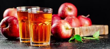 Fresh homemade apple juice. On a black background. photo