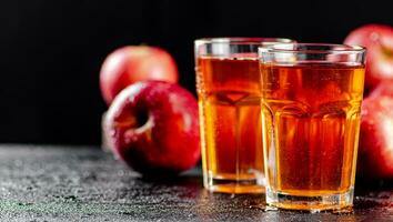 Fresh homemade apple juice. On a black background. photo