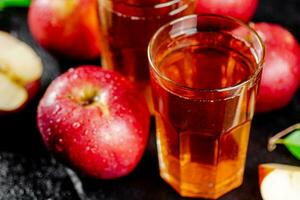 Apple juice on a stone board. photo