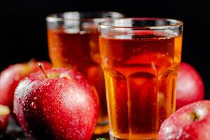 Fresh homemade apple juice. On a black background. photo