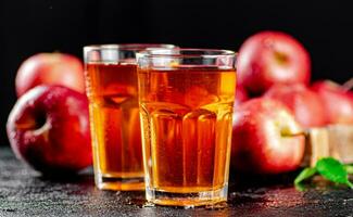 Fresh homemade apple juice. On a black background. photo