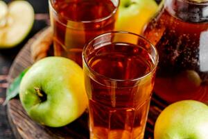 Apple juice on a wooden tray. photo