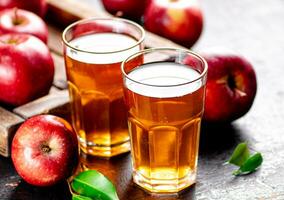 A glass of apple juice on the table. photo