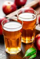 A glass of apple juice on the table. photo