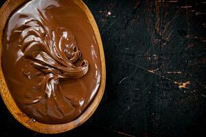 Hazelnut butter in a plate with a spoon. photo