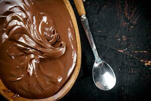 Hazelnut butter in a plate with a spoon. photo