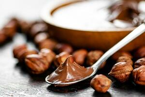 Hazelnut butter in a spoon on the table. photo