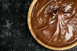 Wooden plate with hazelnut butter. photo