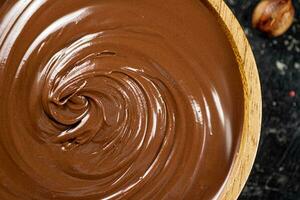 Hazelnut butter in a wooden plate. photo