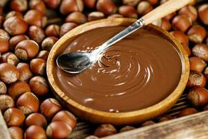 Hazelnut butter on a wooden plate. photo