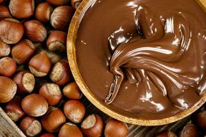 Hazelnut butter on a wooden plate. photo