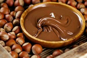 Hazelnut butter on a wooden plate. photo