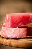Fresh raw tuna steak on the table. photo