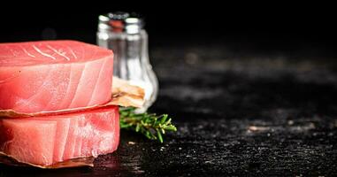 Raw tuna with spices and rosemary. photo