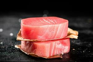 Raw tuna steaks on the table. photo