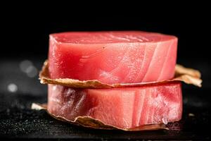 Raw tuna steaks on the table. photo