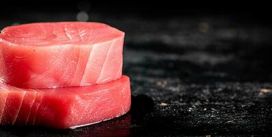 Raw tuna steaks on the table. photo