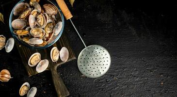 Vongole in a glass bowl on a cutting board. photo