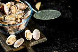 Vongole in a glass bowl on a cutting board. photo