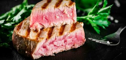 Grilled tuna with parsley on the table. photo