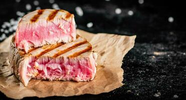 Grilled tuna on paper with salt. photo