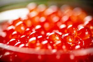 Grains of red caviar. Macro background. photo