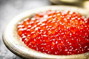 Red caviar in the bowl. photo