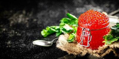 Red caviar on a cutting board with parsley. photo