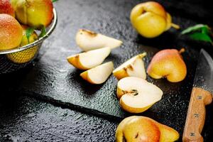 Sliced ripe pear with a knife. photo