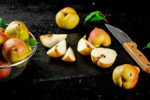 Sliced ripe pear with a knife. photo