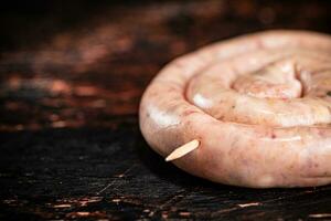 Raw sausage for frying on the table. photo