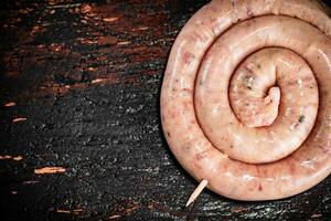 Raw sausage for frying on the table. photo