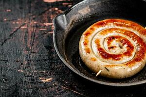 Delicious grilled sausage in a frying pan. photo