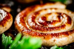 Grilled sausages with parsley on a wooden background. photo