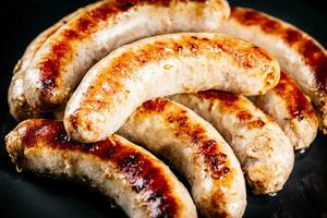 Ready grilled sausages on a plate. photo