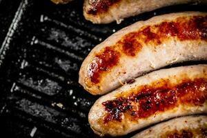 Grilled sausages in a frying pan. photo