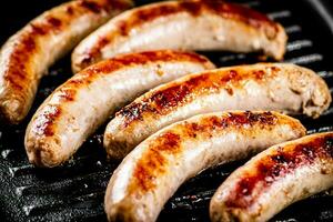 Grilled sausages in a frying pan. photo