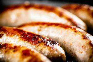 Delicious grilled sausages. Macro background. photo