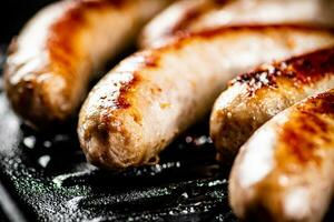 Grilled sausages in a frying pan. photo