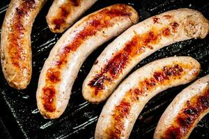 Grilled sausages in a frying pan. photo