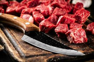 Raw beef sliced on a dark background. photo